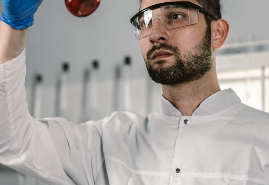 Technician inspecting a well water sample for laboratory analysis